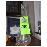 vintage L.E. Smith clear glass swung vase featuring a distinct three-footed base.