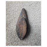 vintage cast iron sad iron, specifically an asbestos-lined model designed to hold heat while ironing clothes.