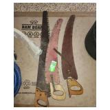 vintage logging saws, specifically a one-man crosscut saw and pruning saws