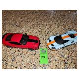 1:18 scale diecast model car of a 2017 Ford GT featuring the iconic Gulf Oil livery and 1/18 scale collectible resin model of a 2021 Ford Mustang Mach 1 in Race Red, manufactured by GT Spirit and :25 