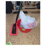 "No-scratch" snow brush, red bin of multiple pairs of garden gloves and brand new microfiber clothes