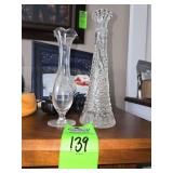 vintage Anchor Hocking clear glass bud vase, specifically in the "Stars and Bars" pattern. And vintage crystal fluted bud vase featuring delicate wheel-cut floral etching and a pedestal base.