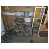 Wooden shelving, scrap wood, galvanized bucket and wood rack with hose