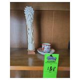 vintage Japanese demitasse teacup and saucer set, likely produced between the 1920s and 1950s. & a vintage Indonesian hand-carved totem made from bleached bovine or water buffalo bone.