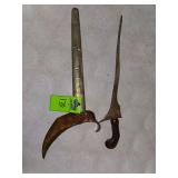 traditional Indonesian dagger known as a Keris (or Kris) and its accompanying sheath. 
The Keris is a distinctive, asymmetrical weapon from Southeast Asia, particularly Indonesia, where it is valued b