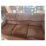 Old couch with throw pillows