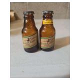 These are vintage Miller High Life mini beer bottles, likely from the 1940s.They were produced by Muth & Son Company based in Buffalo, New York