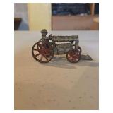 antique cast iron toy tractor, likely manufactured by the Arcade Manufacturing Company in the 1920s.