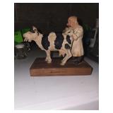 vintage German wooden hand-carved figurine, titled 'Der geplagte Tierarzt' (The Plagued Veterinarian), depicts a humorous scene of a farmer or vet with a cow.
