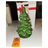 Vintage-style green glazed ceramic tabletop Christmas tree decorated with multicolored miniature plastic bulb inserts.