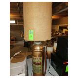 vintage copper Fyr-Fyter foam fire extinguisher has been repurposed into a rustic table lamp featuring a burlap shade