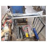 Grease guns, metal rack, snow brush and other items