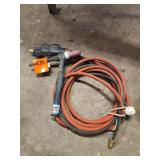 TIG welding torch paired with a coiled coaxial or power/gas hose bundle and a brass fitting.