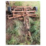 Field cultivator or disc/harrow implement (likely a vintage or mid-20th-century towed/mounted tillage tool)