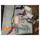 paint-mixing tools, jars, and several pneumatic paint spray guns