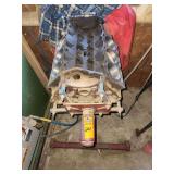 Bare V8 engine block mounted onto a heavy-duty, red automotive engine stand, 350 Rocket