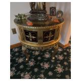 This item appears to be a vintage French Provincial or Louis XIV-style round drum side table featuring a glass top and cabinet doors. [1] (https://www.ebth.com/items/3673369-vintage-french-provincial-