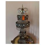 This appears to be a vintage Loevsky & Loevsky (L&L WMC) Hollywood Regency-style tiered waterfall crystal table lamp or candelabra, manufactured around the late 1960s. [1] (https://www.etsy.com/ca/lis