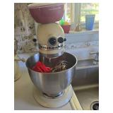 Kitchen Aid mixer with attachements, measuring cups, and small bowls