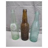 Three Embossed Glass Bottles