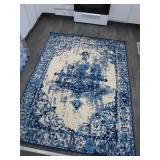 Blue and Cream Area Rug With Distressed Pattern