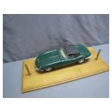 Green Model Car on Wood Display