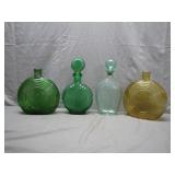 Four Embossed Glass Bottles
