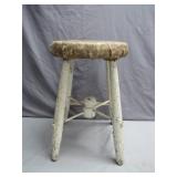 Distressed Wooden Stool with Worn Upholstery