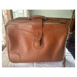 Vintage leather suit case on wheels