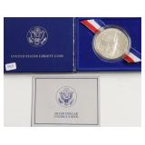 ELLIS ISLAND SILVER DOLLAR W BOX PAPERS