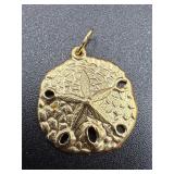 14k yellow gold .3 gram charm sand dollar