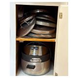 Cabinet lot.  Pots and assorted lids