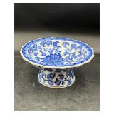 white and blue ceramic pedestal dish