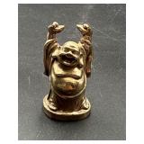 2ï¿½ vintage figurine depicts a laughing Buddha