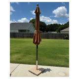 Outdoor umbrella in stone umbrella stand