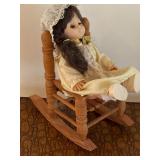 Vintage doll in wooden rocking chair