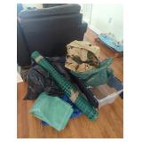 Pile of hunting and fishing items tarps snow