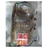 Three 1 gallon glass jugs. One cranberry juice