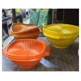 Nesting vintage Tupperware bowls. One lid is bent