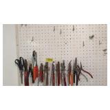 Rack of hand tools. Leather punch, scissors, side