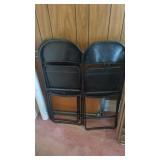 Folding table and three black chairs