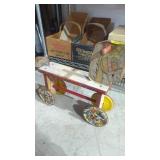Vintage women with metal wheels toy