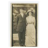 Young Couple Posing in Front of Crazy Quilt RPPC