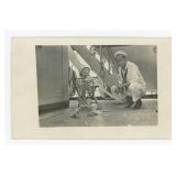 Navy Man Gambling with Skeleton RPPC Postcard