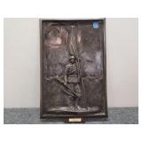 Brass wall plaque featuring uniformed soldier
