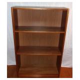 Solid pressboard bookshelf.