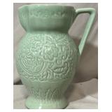 1940's pitcher w/ handle & embossed floral motifs.