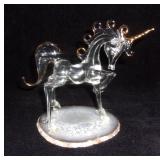 Crystal unicorn on geode slice base.