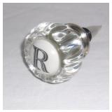 Glass door knob style decanter stopper.
