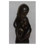 Vintage couple embraced statue.